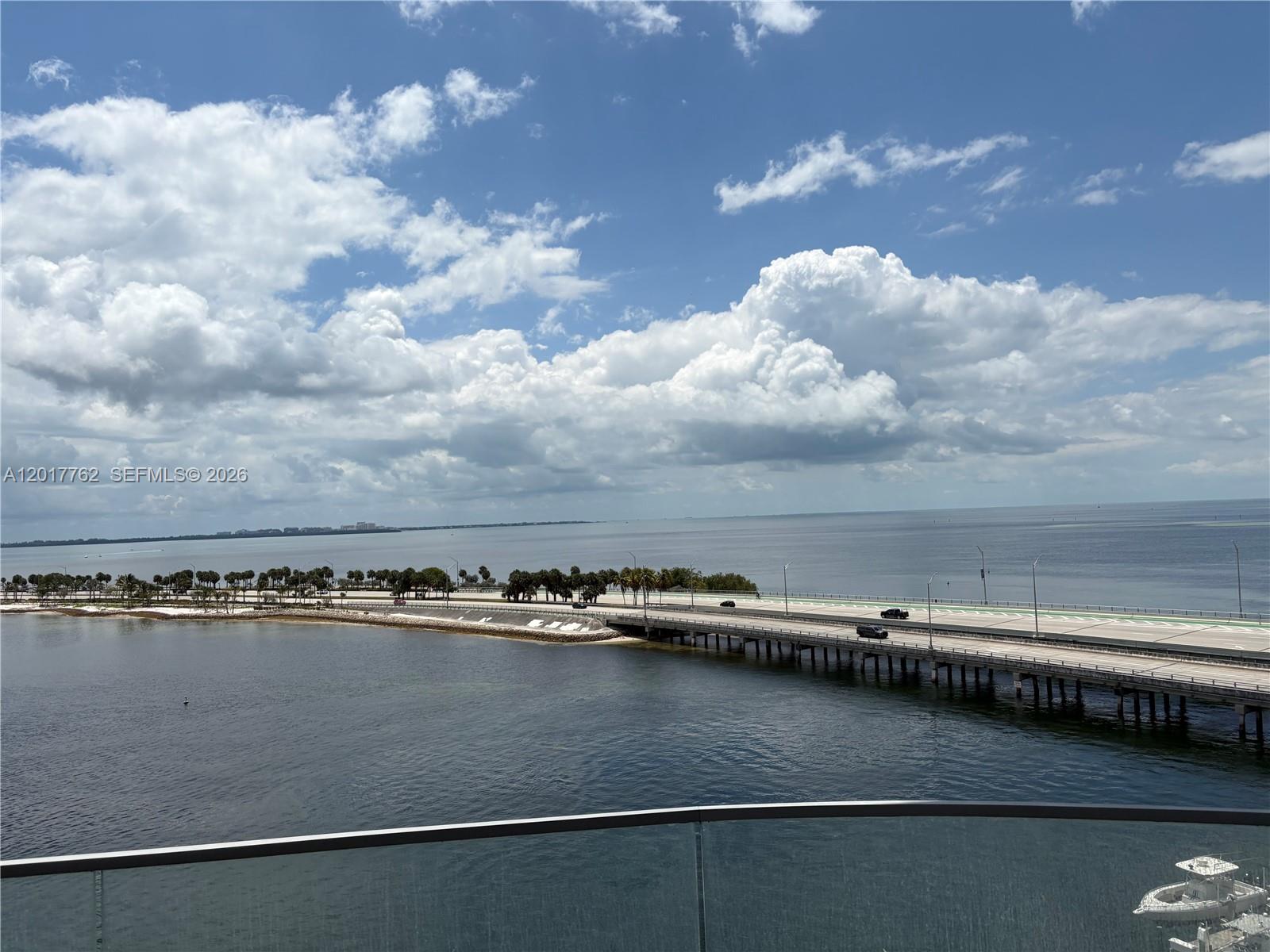 An elevated view shows a bridge extending over water toward a tree-lined coastal road — 175 SE 25 Road # 602, Miami FL 33129, MIAMI, FL