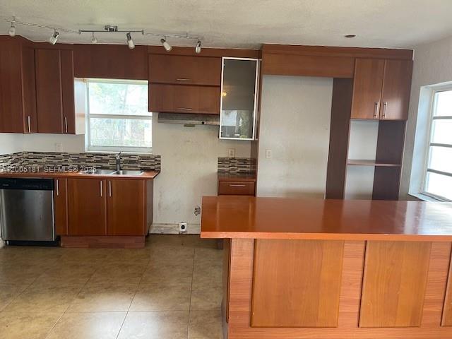 A kitchen features wood cabinets, a stainless steel dishwasher, and a large wooden island — 758 SW 3rd Pl, Dania Beach FL 33004, DANIA BEACH, FL