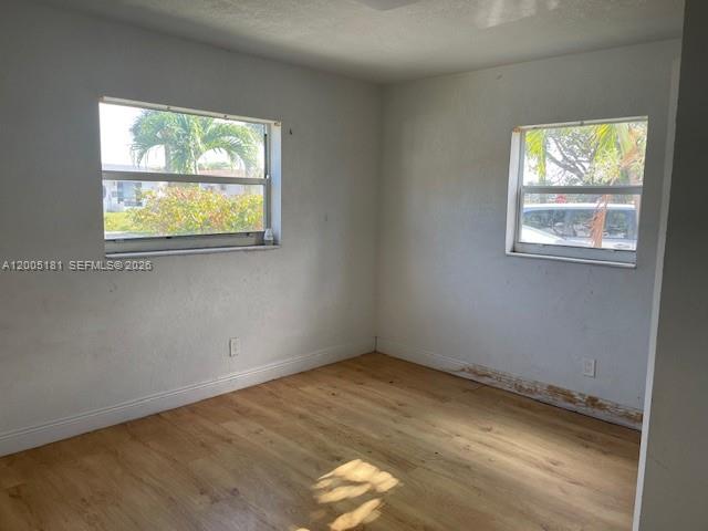 An empty room features light wood-look flooring, white walls, and two windows — 758 SW 3rd Pl, Dania Beach FL 33004, DANIA BEACH, FL
