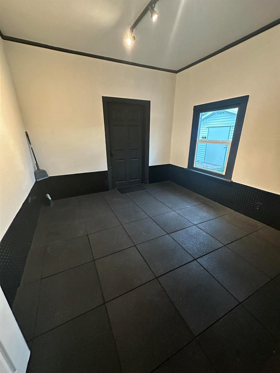 A room with black rubber floor tiles, black wainscoting, and a black door and window frame — 729 SE 2nd Avenue, Delray Beach FL 33483, DELRAY BEACH, FL