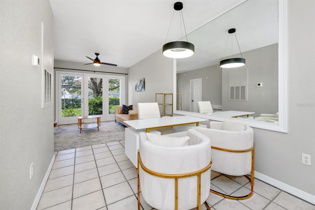A home office features a white desk, two gold-accented chairs, and a large wall mirror — 2954 SADINA STREET UNIT Tower 3, KISSIMMEE, FL