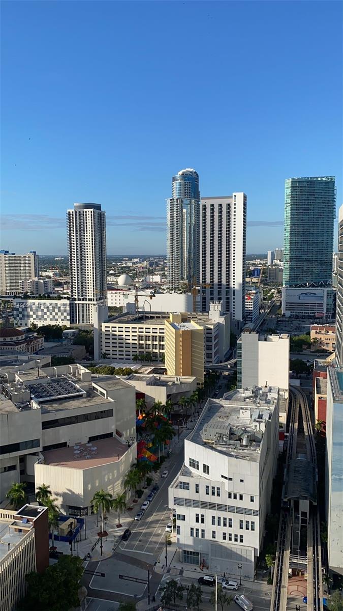An elevated view of a city skyline featuring several high-rise buildings and a street below — 133 NE 2nd Ave # 2805, Miami FL 33132, MIAMI, FL