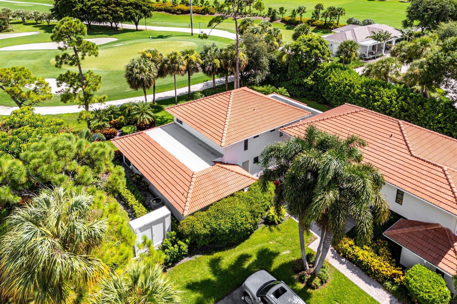 An aerial view shows a house with a terracotta tile roof next to a golf course — 4085 Kittiwake Court, Boynton Beach FL 33436, BOYNTON BEACH, FL