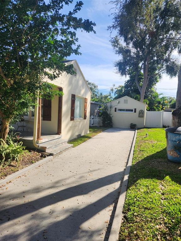 A concrete driveway leads from the side of a house to a detached garage — 734 37TH AVENUE N, ST PETERSBURG, FL