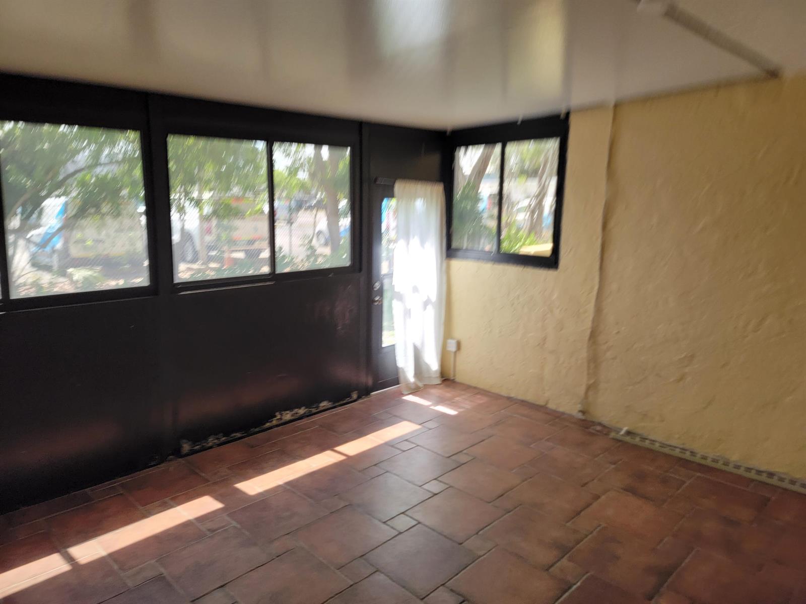 A concrete walkway winds between two-story tan apartment buildings surrounded by palm trees and landscaping — 791 SE 1st Way # 74, Deerfield Beach FL 33441, DEERFIELD BEACH, FL