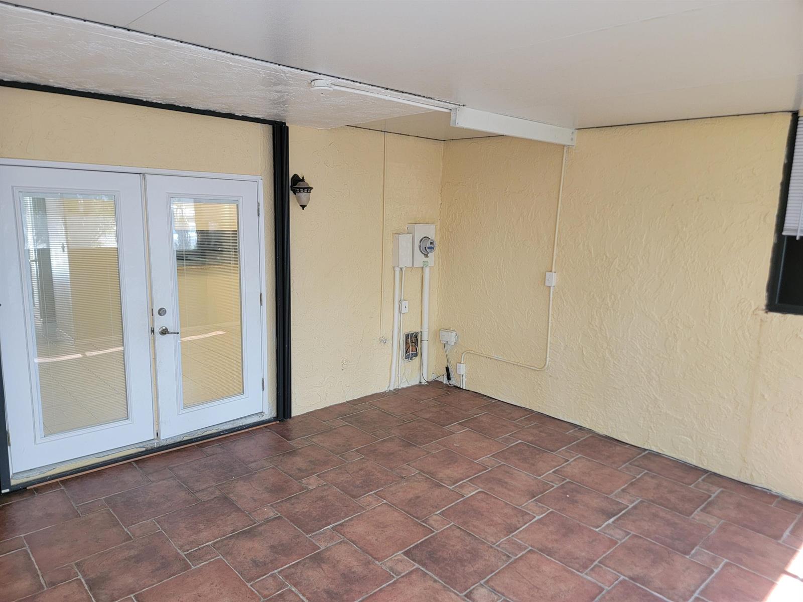A view from a sliding glass door looking out onto a balcony and neighboring buildings — 791 SE 1st Way # 74, Deerfield Beach FL 33441, DEERFIELD BEACH, FL