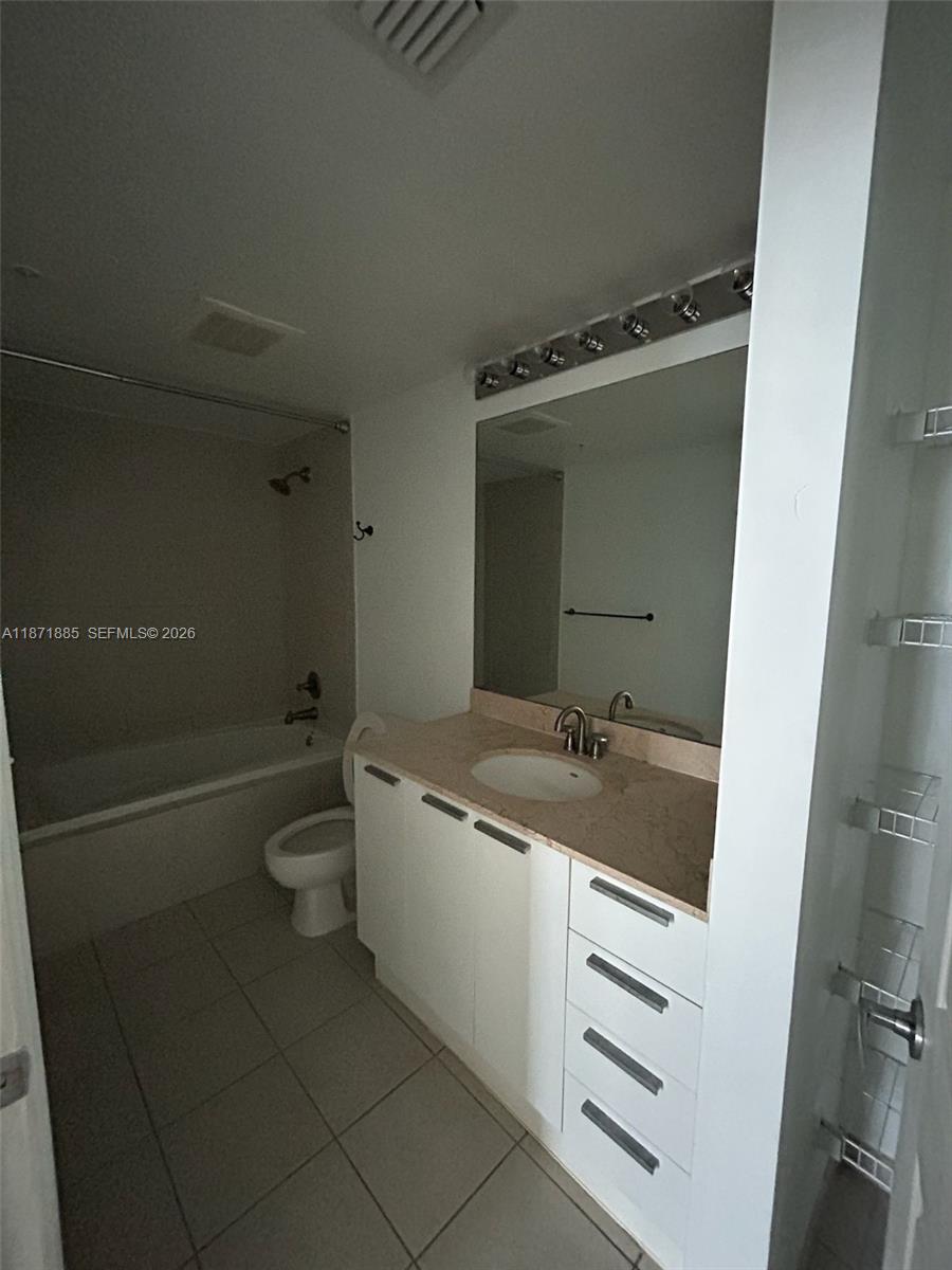 A bathroom features a vanity with a light-colored countertop, a mirror, and a tub-shower combo — 140 S Dixie Hwy # 816, Hollywood FL 33020, HOLLYWOOD, FL