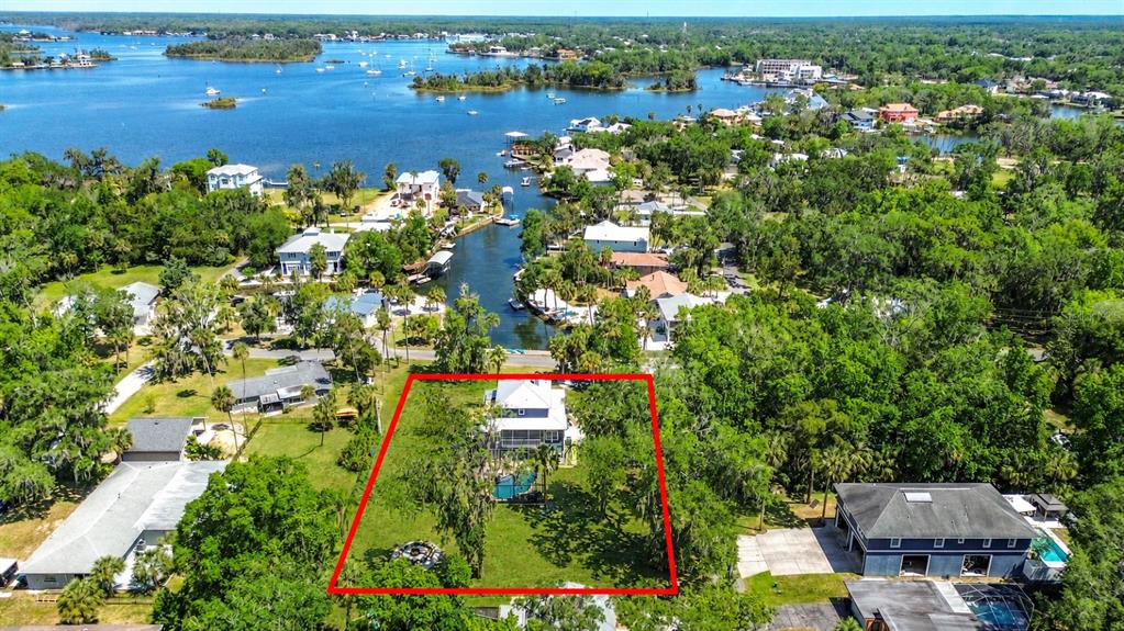 An aerial view shows a house with a pool and large yard outlined in red — 980 N GARDENVIEW TERRACE, CRYSTAL RIVER, FL