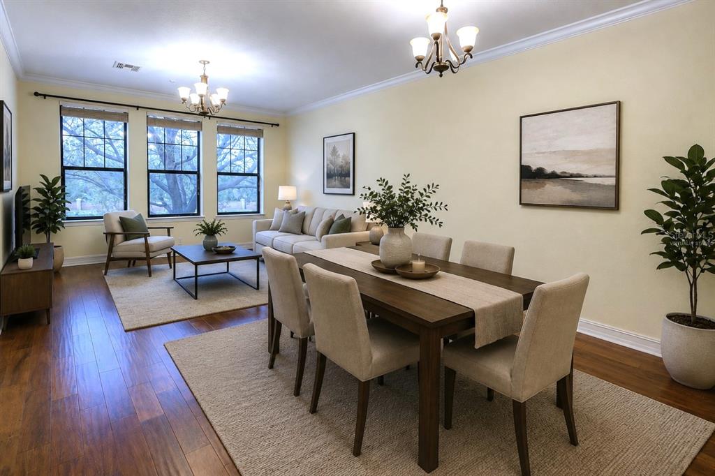 A living and dining room with hardwood floors, neutral walls, and large windows — 4624 MESSINA DRIVE, LAKE MARY, FL