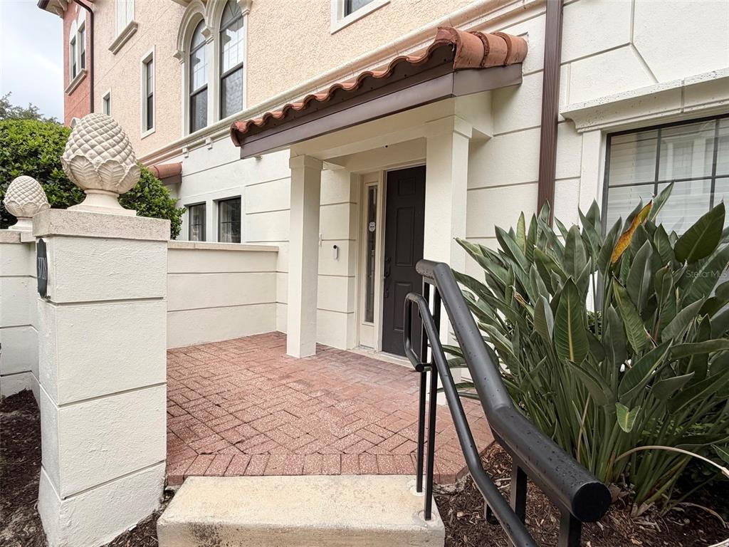 The exterior entrance features a brick patio, a dark door, and a small tiled awning — 3728 MESSINA DRIVE, LAKE MARY, FL
