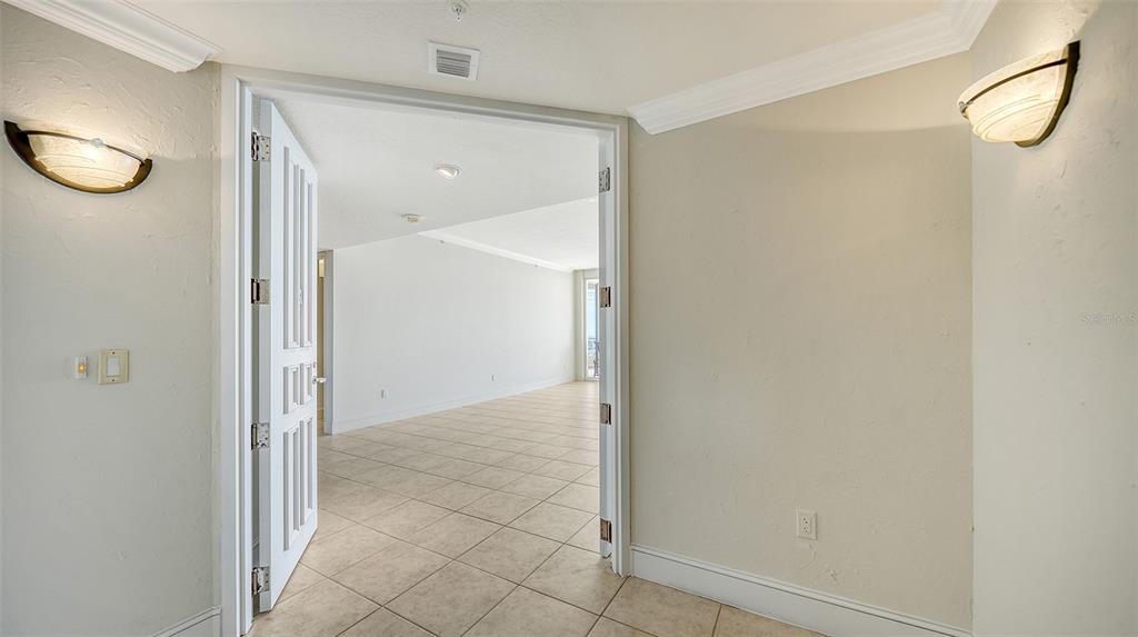 A tiled entryway leads through double doors into a bright, open-concept living area — 3010 GRAND BAY BOULEVARD UNIT 493, LONGBOAT KEY, FL