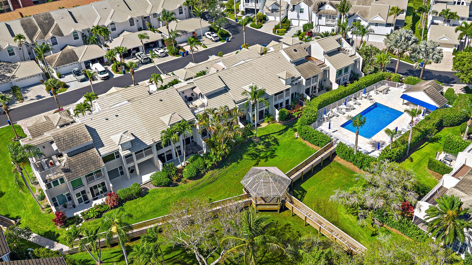 An aerial view shows a residential complex with a swimming pool, gazebo, and wooden walkways — 1000 N Us Highway 1 # 652, Jupiter FL 33477, JUPITER, FL