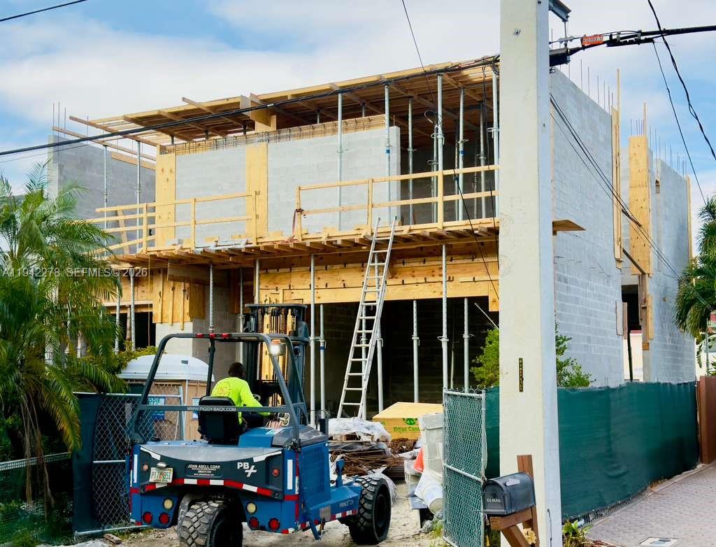 A construction site shows a two-story concrete block building with wooden scaffolding and support beams — 2377 SE 15th St, Pompano Beach FL 33062, POMPANO BEACH, FL