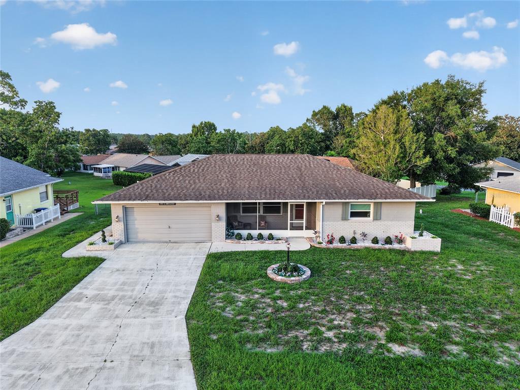An aerial view of a single-story ranch-style house with a concrete driveway and lawn — 3705 N HONEYLOCUST DRIVE, BEVERLY HILLS, FL