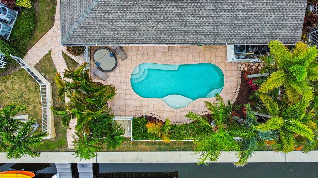 An aerial view shows a house with a swimming pool, hot tub, and palm trees — 432 ISLEBAY DRIVE, APOLLO BEACH, FL