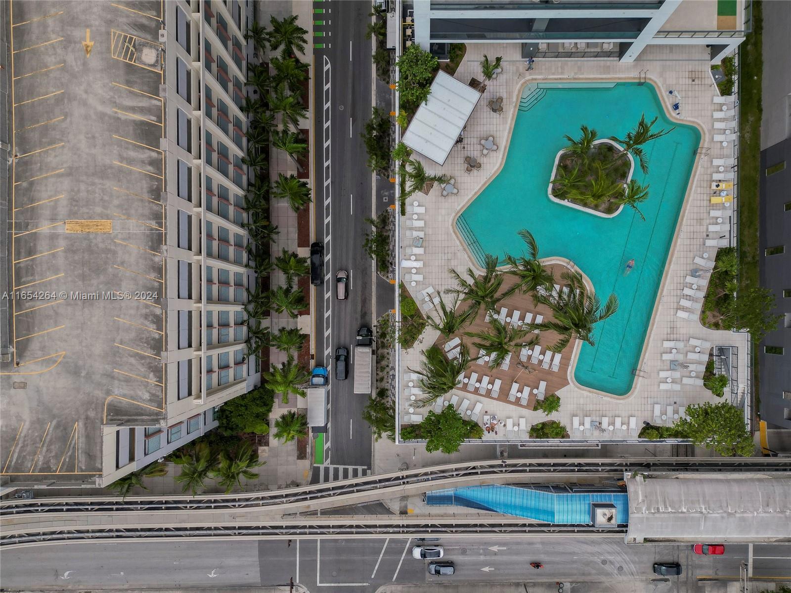 An aerial view shows a swimming pool, a parking garage, and a nearby transit track — 601 NE 1st Ave # 2905, Miami FL 33132, MIAMI, FL