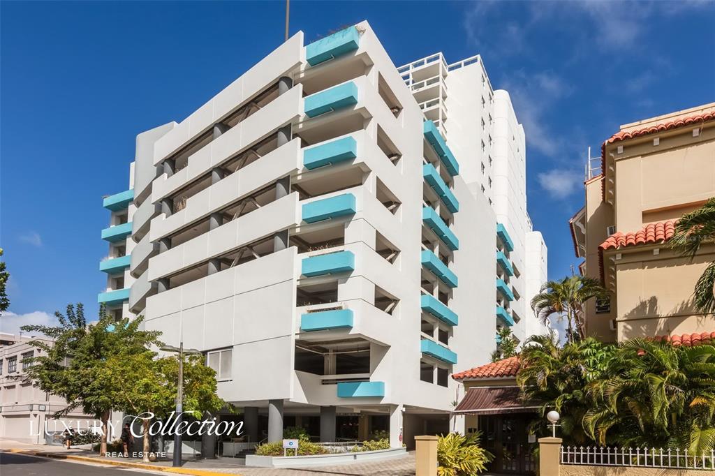 A multi-story white apartment building features blue balcony accents and a ground-level parking area — 1315 ASHFORD AVENUE AVENUE UNIT 905, SAN JUAN, PR