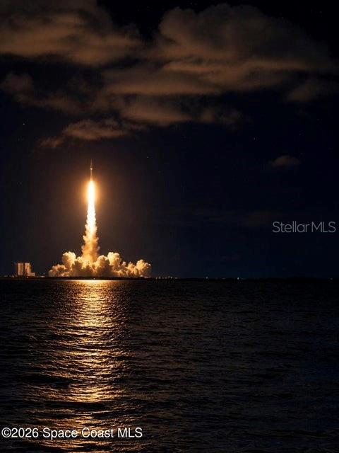 A rocket launches into the night sky above a body of water — 140 BELLEWOOD STREET, TITUSVILLE, FL