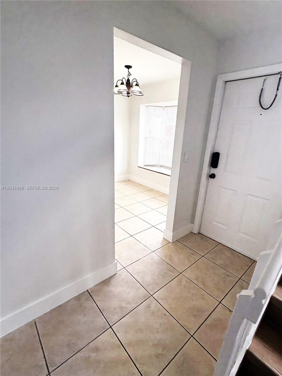 A tiled entryway leads to a dining area with a bay window and chandelier — 3743 NW 122nd Ter, Sunrise FL 33323, SUNRISE, FL