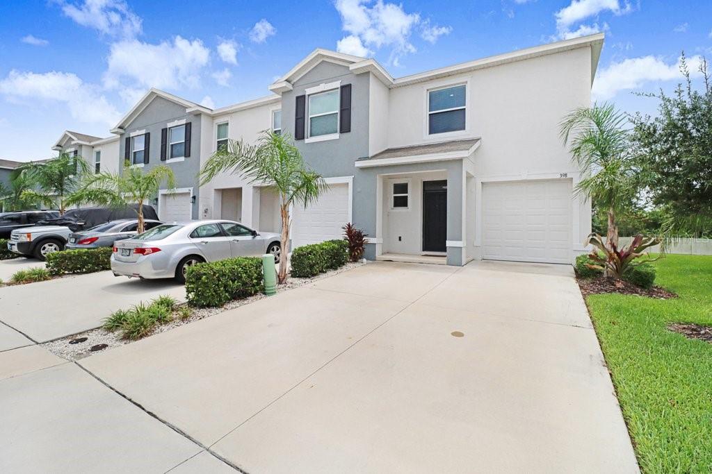 A two-story townhouse with a white and gray exterior, a garage, and a concrete driveway — 398 MANGROVE SHADE CIRCLE, APOLLO BEACH, FL