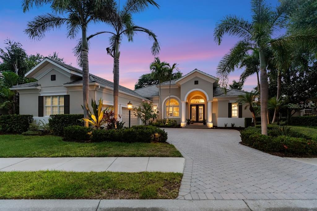A screened-in patio features a swimming pool, outdoor seating area, and views into the home — 7312 GREYSTONE STREET, LAKEWOOD RANCH, FL