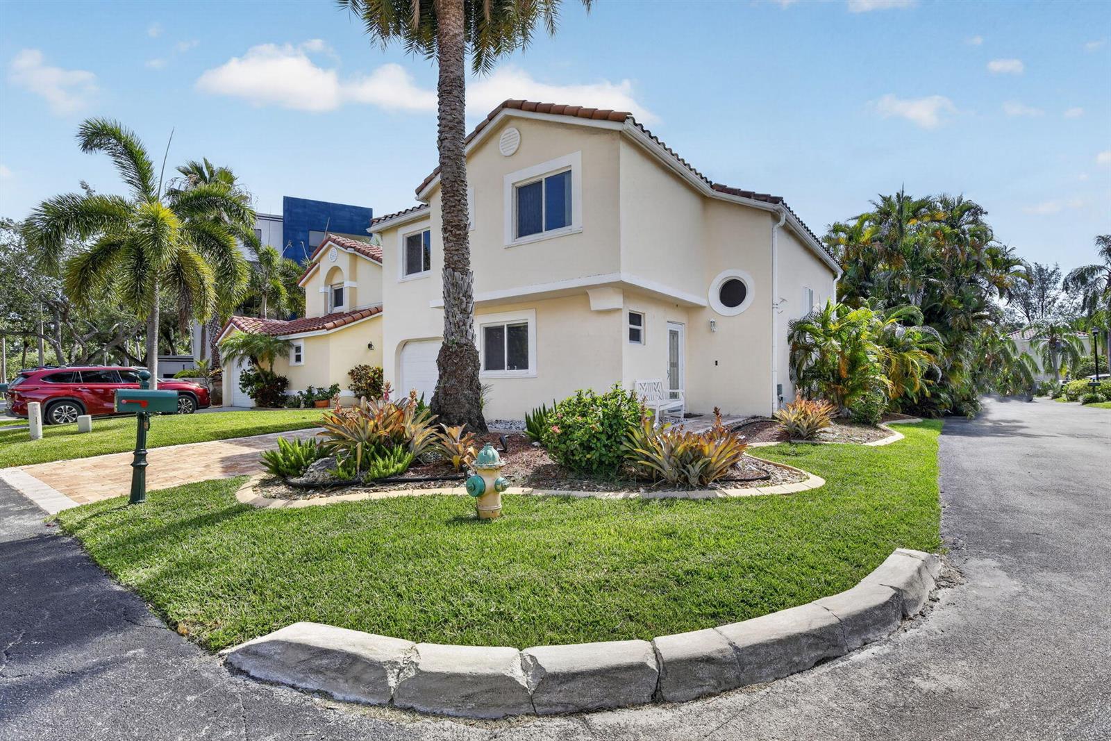 A two-story, light-colored stucco house with a palm tree and fire hydrant in the yard — 1306 SE 5th Court, Dania Beach FL 33004, DANIA BEACH, FL