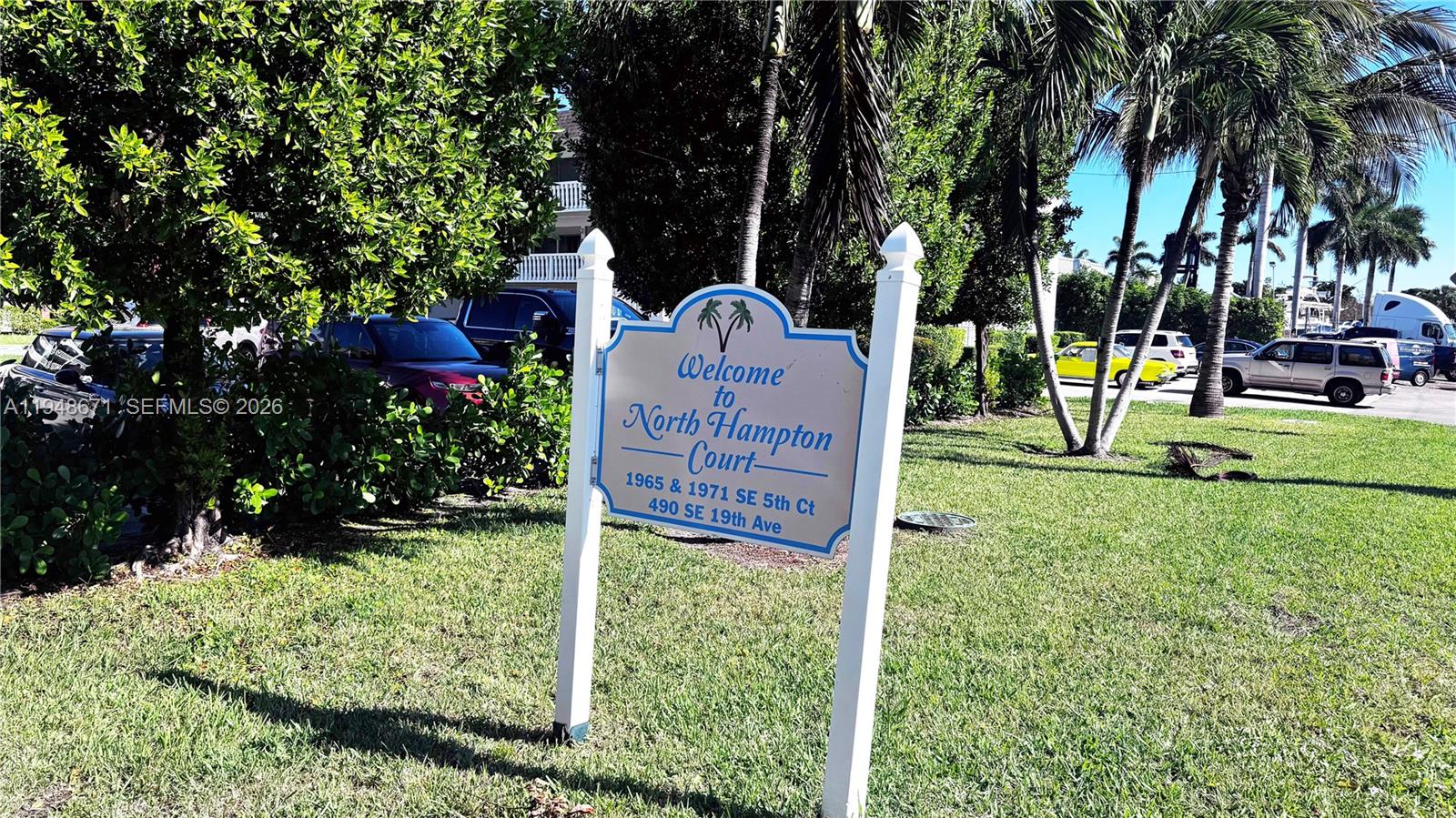 A sign welcomes visitors to North Hampton Court in a grassy area with palm trees — 1965 SE 5th Ct # 203, Pompano Beach FL 33060, POMPANO BEACH, FL