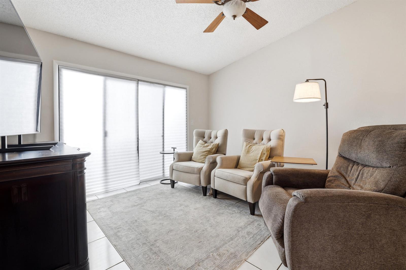 A living room features two beige armchairs, a brown recliner, and a sliding glass door — 22316 Pineapple Walk Drive, Boca Raton FL 33433, BOCA RATON, FL