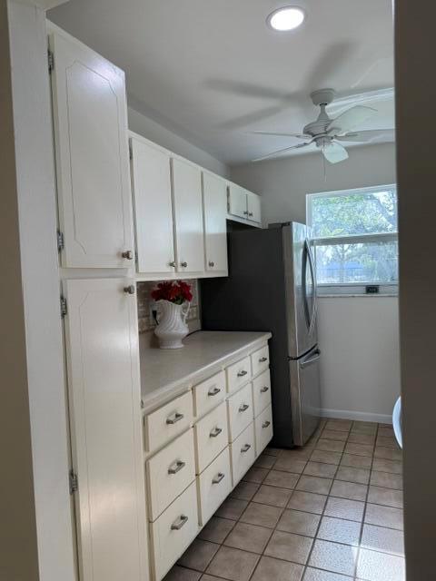 A kitchen features white cabinets, a stainless steel refrigerator, and tiled flooring — 7293 W Oakridge Circle, Lake Worth FL 33462, LAKE WORTH, FL
