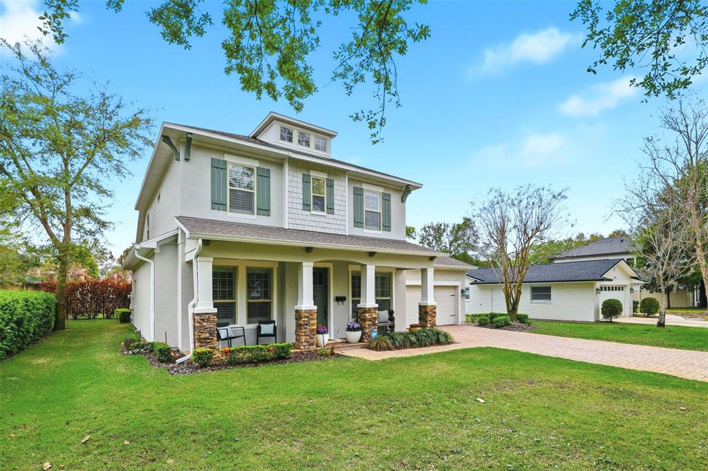 A covered patio features outdoor furniture, a ceiling fan, and a view of a pool — 1750 CAROLLEE LANE, WINTER PARK, FL