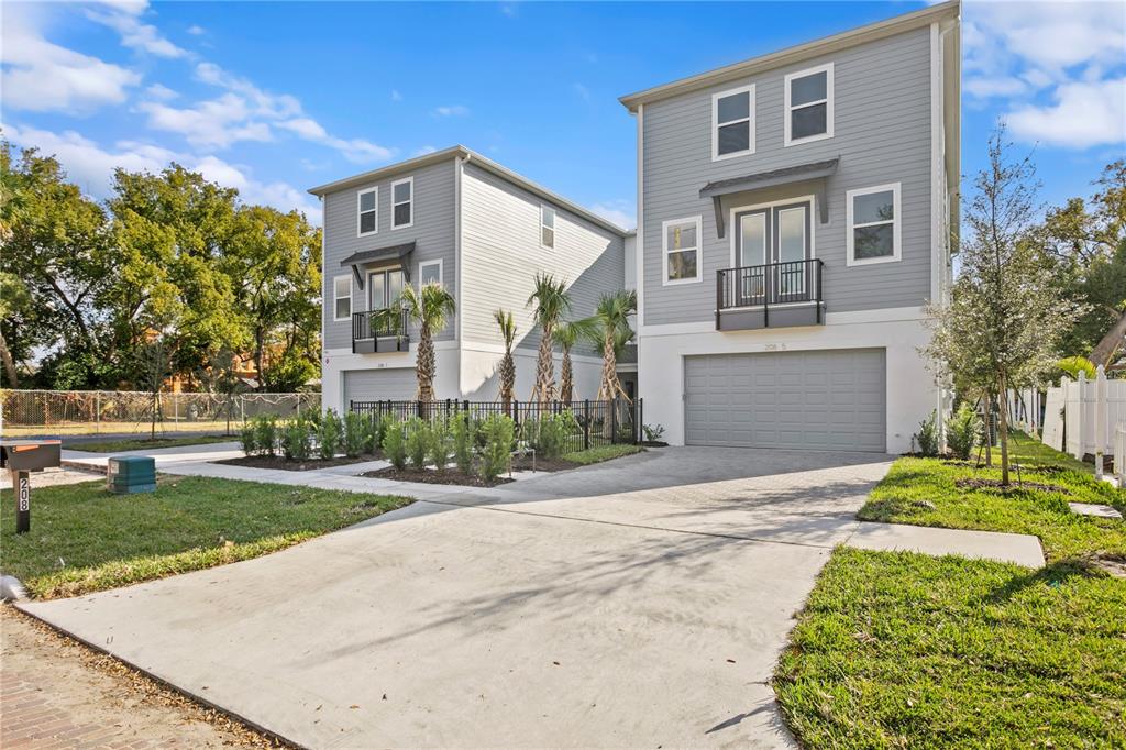 Two modern, three-story gray houses with attached garages and balconies stand side-by-side — 208 W FRANCES AVENUE UNIT 3, TAMPA, FL