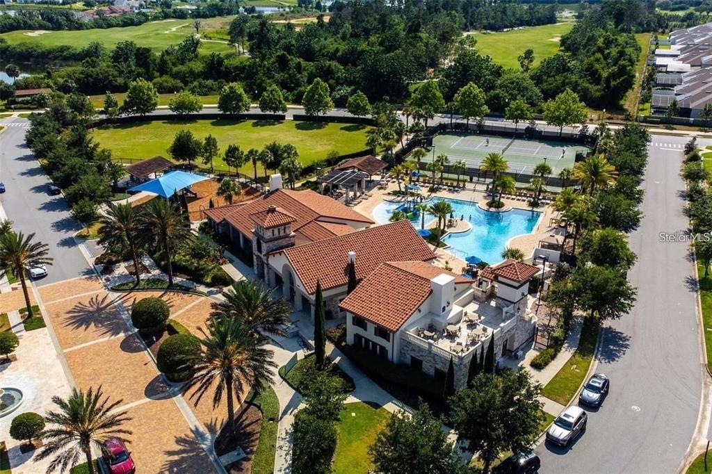 An aerial view shows a community clubhouse with a pool, tennis courts, and parking areas — 14654 WATOWAN ALLEY, WINTER GARDEN, FL