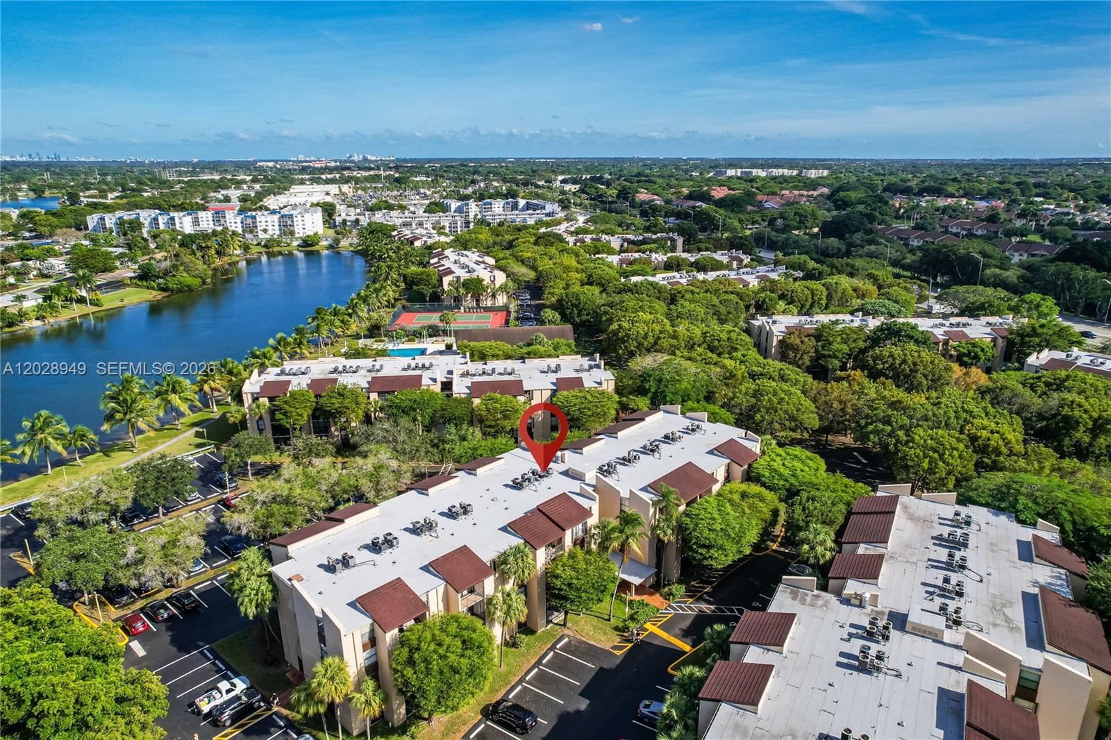 An aerial view shows a multi-story apartment building with a red marker on the roof — 14501 N Kendall Dr # 212H, Miami FL 33186, MIAMI, FL