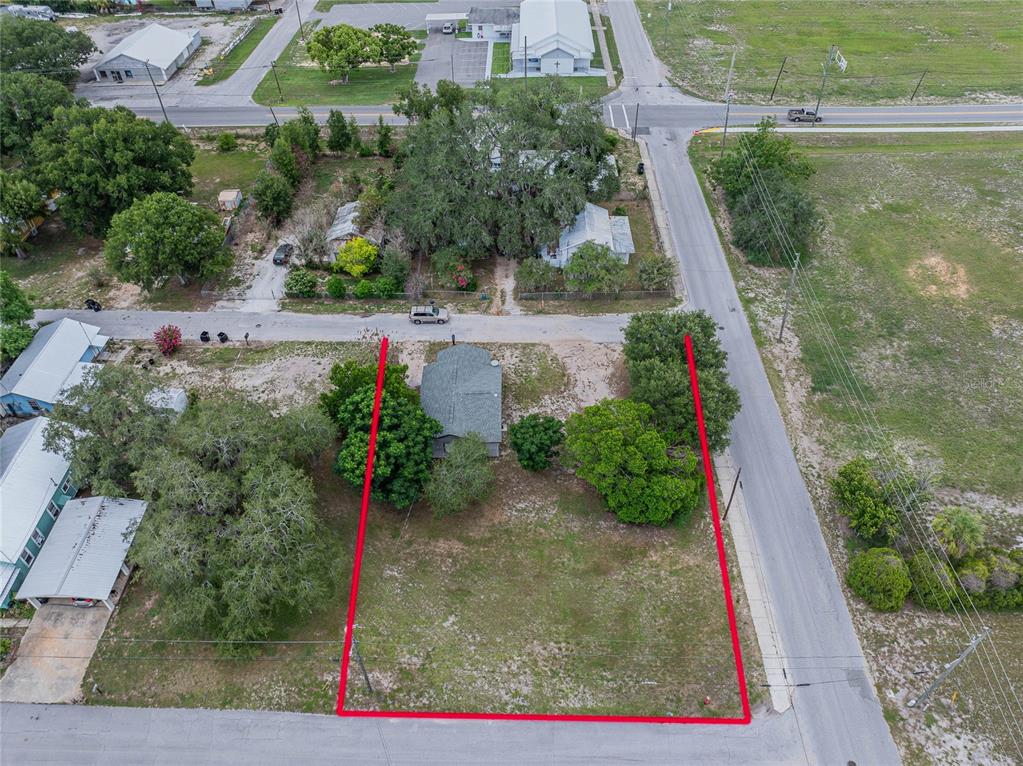 An aerial view shows a vacant lot outlined in red next to a small house — 5 NORTH STREET, FROSTPROOF, FL