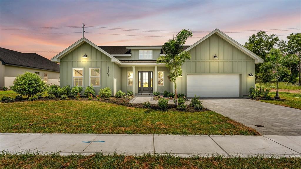 An entryway features a white front door with glass panels, light wood flooring, and walls — 5367 CLUBHOUSE HILLS LANE, LAKELAND, FL
