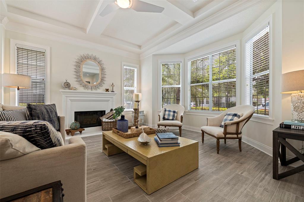 A kitchen features white cabinets, black granite countertops, stainless steel appliances, and a breakfast bar — 125 COMMONWEALTH COURT N, ST PETERSBURG, FL