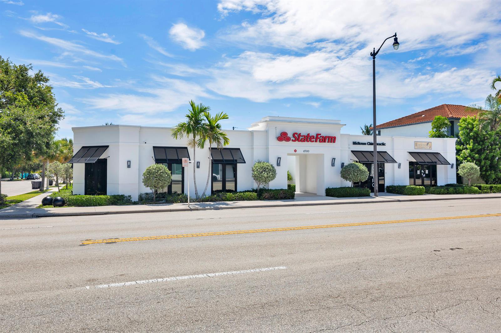 A white commercial building with black awnings and a State Farm sign sits along a road — 6500 S Dixie Highway # A, West Palm Beach FL 33405, WEST PALM BEACH, FL