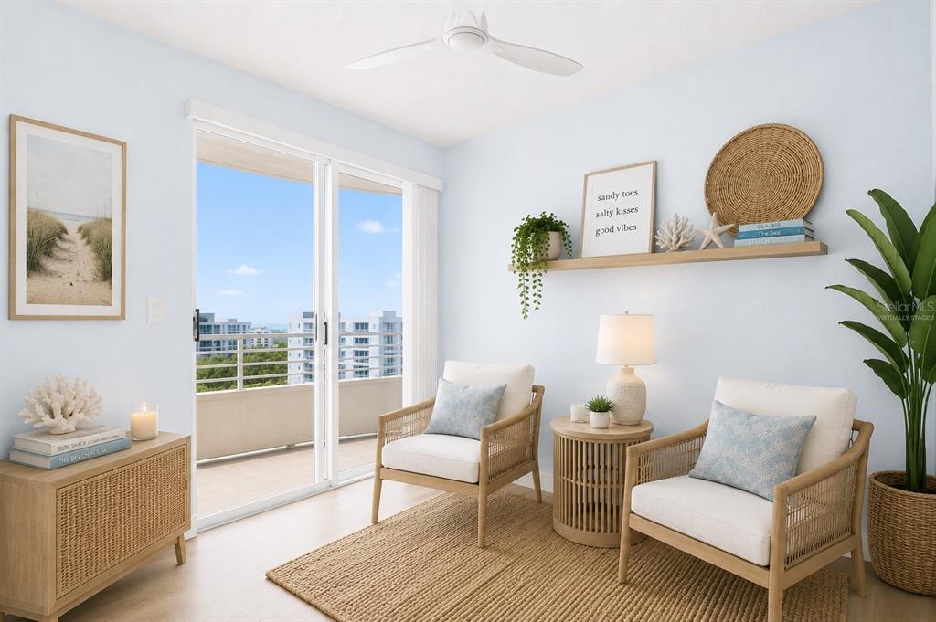 This virtually staged living area features two rattan chairs, a side table, and a balcony — 7963 SAILBOAT KEY BOULEVARD S UNIT PH801, SOUTH PASADENA, FL