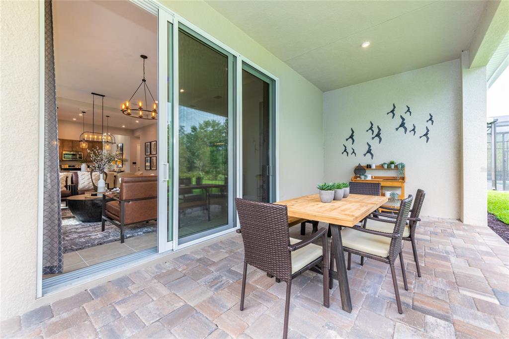 A bright entryway features a tiled floor, a console table with lamps, and a powder room — 1629 LAKE RESERVE DRIVE, DELAND, FL