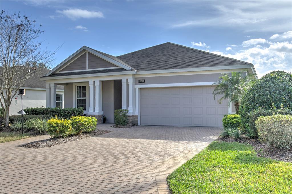 A single-story house with a paved driveway, a two-car garage, and a covered front porch — 19744 FORT KING RUN, BROOKSVILLE, FL