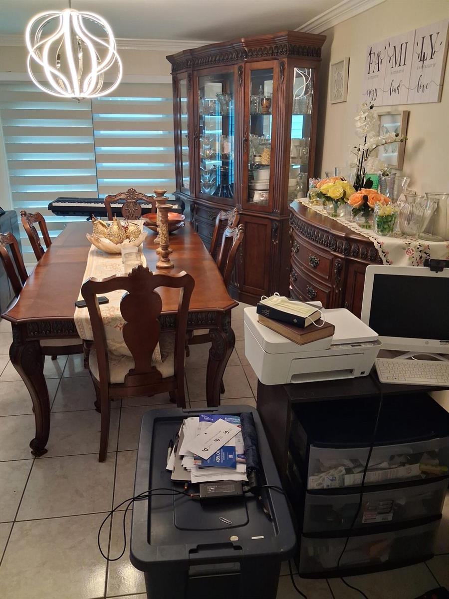 A dining room features a wooden table and hutch, a printer, and a storage bin — 9752 NW 37th Street # 7g, Sunrise FL 33351, SUNRISE, FL