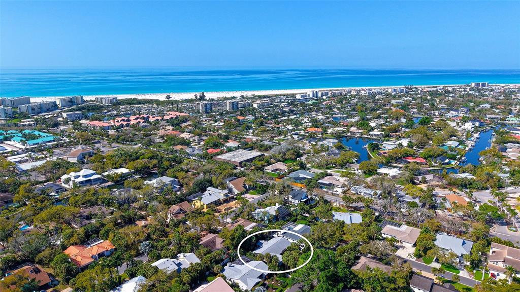 An aerial view shows a residential neighborhood near a beach with a house circled — 5345 SIESTA COURT, SARASOTA, FL