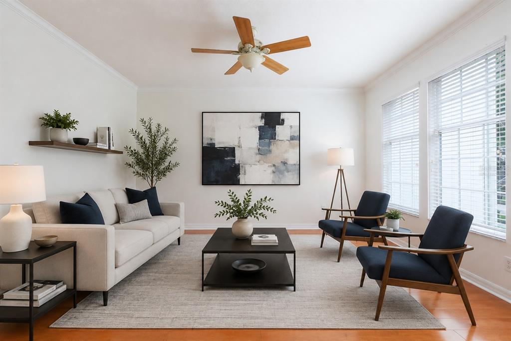 A living room features a beige sofa, two navy armchairs, a coffee table, and wall art — 1003 JUEL STREET, ORLANDO, FL