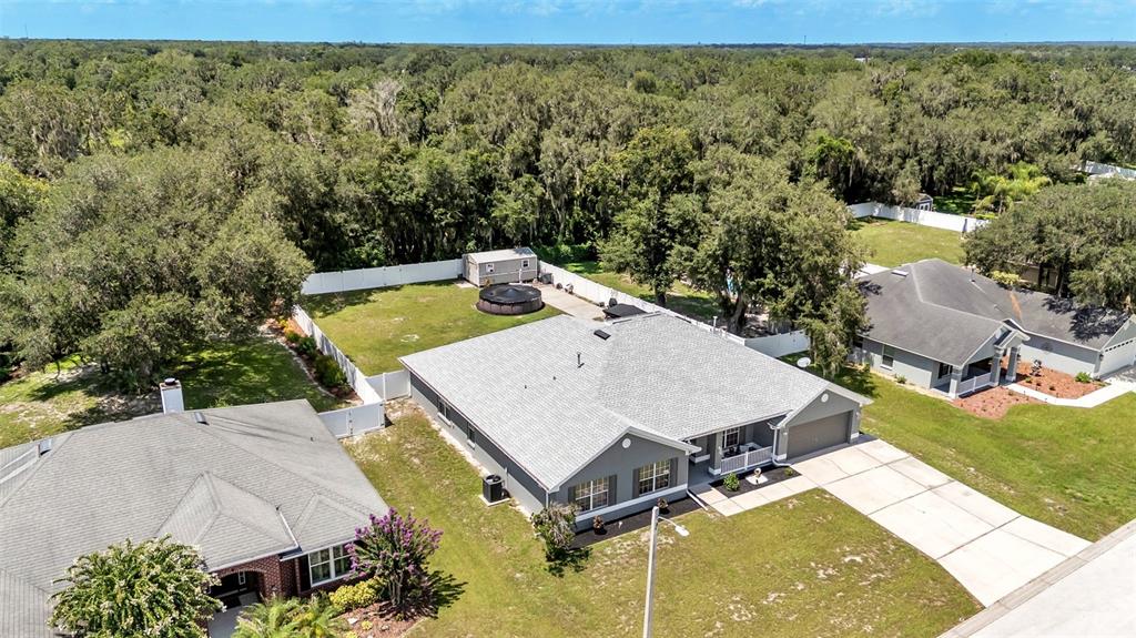 An aerial view shows a gray house with a fenced backyard and a small pool — 2855 BLACKWATER OAKS DRIVE, MULBERRY, FL