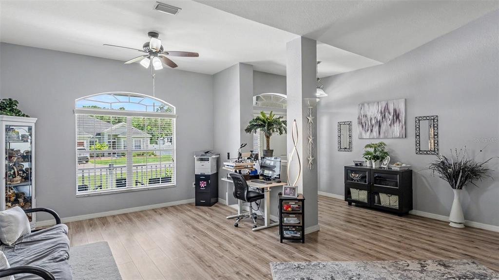 An aerial view shows a gray single-story house with a two-car garage and fenced backyard — 2855 BLACKWATER OAKS DRIVE, MULBERRY, FL