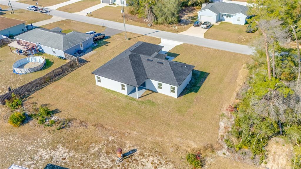 An aerial view shows a single-story house with a dark roof and a large yard — 3110 SW 127TH LANE ROAD, OCALA, FL