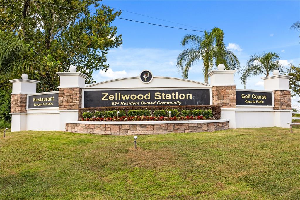 A white mobile home features a screened-in porch, a concrete driveway, and a covered carport — 4133 OAK GROVE ROAD UNIT 16, ZELLWOOD, FL
