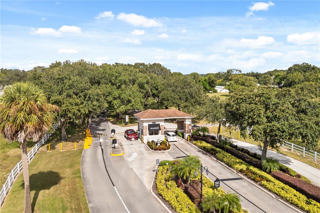 A single-story mobile home with a carport and a screened porch sits on a lawn — 4133 OAK GROVE ROAD UNIT 16, ZELLWOOD, FL