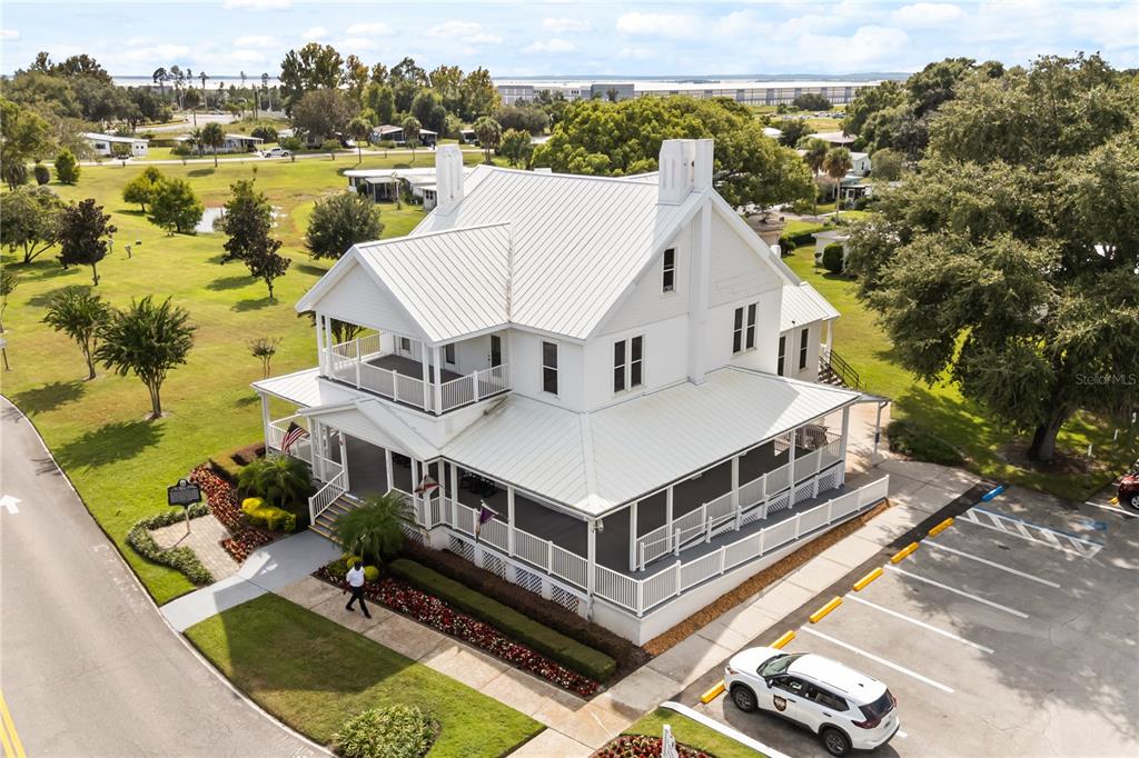 A covered porch features light-colored siding, two entry doors, and a concrete floor — 4133 OAK GROVE ROAD UNIT 16, ZELLWOOD, FL