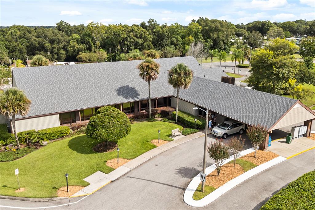 A living room with a coffee table, a hutch, and a sliding door to a porch — 4133 OAK GROVE ROAD UNIT 16, ZELLWOOD, FL